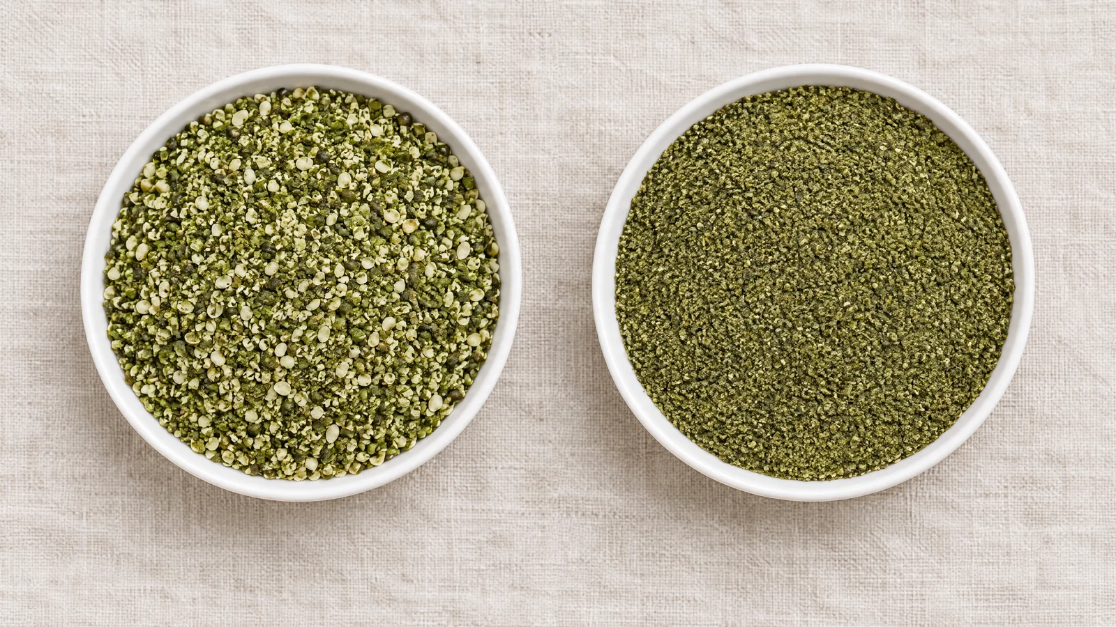 Two shallow white ceramic dishes on pale linen, left holding coarse granular green smoothie hemp and right holding finer green pressed hempseed cake meal